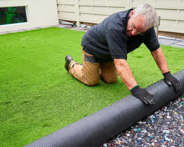 an expert installing turf