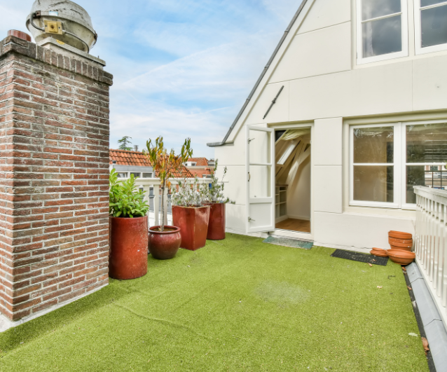 a balcony with green artificial turf